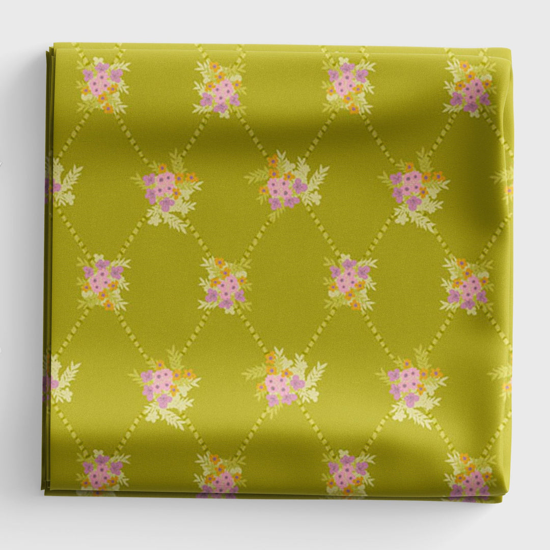 Green fabric with floral pattern on a white background
